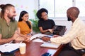 Diverse development team discusses code during code review meeting, programming Royalty Free Stock Photo