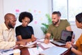 Diverse development team discusses code during code review meeting, programming Royalty Free Stock Photo