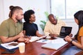 Diverse development team discusses code during code review meeting, programming Royalty Free Stock Photo