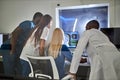 Diverse Doctors discussing studying Mammogram film x-ray of patient & x27;s head for brain, skull injury on computer
