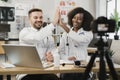 Diverse doctors giving high five during vlog recording Royalty Free Stock Photo