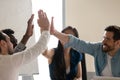 Diverse employees giving high five at meeting, celebrating success Royalty Free Stock Photo