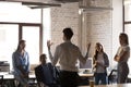 Diverse employees listening team leader during briefing