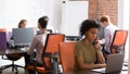 Diverse employees working in modern room sitting in shared office