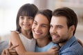 Diverse family with little daughter looking at camera