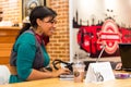 Diverse Female Customers using Internet in a Coffee Shop