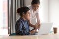 Diverse female mentor and intern talking pointing on laptop Royalty Free Stock Photo