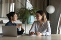 Diverse female office employees discussing project, talking at meeting table Royalty Free Stock Photo