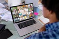 Diverse female teacher and students at table with documents having laptop video call Royalty Free Stock Photo