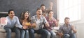 Football fans emotionally watching game in the living room Royalty Free Stock Photo