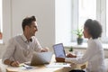 Diverse friendly colleagues talking at workplace working togethe Royalty Free Stock Photo