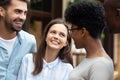 Diverse friends girls and guys standing laughing outdoors