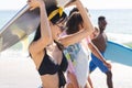 Diverse friends, a group of young adults, enjoy a sunny beach day, with copy space Royalty Free Stock Photo