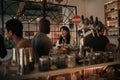 Diverse friends talking over drinks in a bar at night Royalty Free Stock Photo