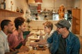 Diverse friends talking over food and drinks in a bistro Royalty Free Stock Photo