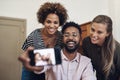 Diverse, fun and happy business people taking a selfie on a phone in an office together. Smiling group of colleagues and Royalty Free Stock Photo