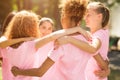 Diverse Girls In Breast Cancer T-Shirts Embracing Standing In Park