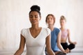 Diverse girls sitting in lotus position doing yoga