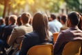 Diverse group backs of young people sitting outdoors man woman students listening speaker watching presentation Royalty Free Stock Photo