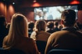 Diverse group backs of young people sitting outdoors man woman students listening speaker watching presentation Royalty Free Stock Photo