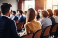 Diverse group backs of young people sitting outdoors man woman students listening speaker watching presentation Royalty Free Stock Photo