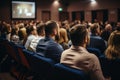 Diverse group backs of young people sitting outdoors man woman students listening speaker watching presentation Royalty Free Stock Photo