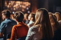 Diverse group backs of young people sitting outdoors man woman students listening speaker watching presentation Royalty Free Stock Photo