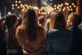 Diverse group backs of young people sitting outdoors man woman students listening speaker watching presentation Royalty Free Stock Photo