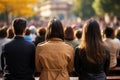 Diverse group backs of young people sitting outdoors man woman students listening speaker watching presentation Royalty Free Stock Photo