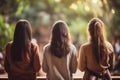 Diverse group backs of young people sitting outdoors man woman students listening speaker watching presentation Royalty Free Stock Photo