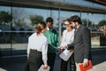 Diverse group of business colleagues discussing project in urban city setting on a sunny day Royalty Free Stock Photo