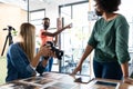 Diverse group of business colleagues wearing masks brainstorming holding camera in meeting room Royalty Free Stock Photo