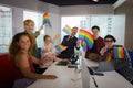 Diverse business people with LGBTQ have rainbow flag on hand