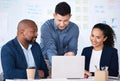 Diverse group of business people talking in a meeting and using technology and paperwork in a boardroom. Team of Royalty Free Stock Photo