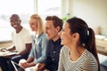 Diverse businesspeople laughing together during an office presen Royalty Free Stock Photo