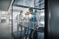 Businesspeople brainstorming together on the glass wall of a boa Royalty Free Stock Photo