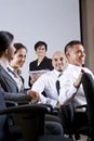 Diverse group businesspeople watching presentation Royalty Free Stock Photo