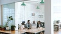 Diverse businesspeople using a laptop together in an office boardroom Royalty Free Stock Photo