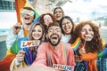 Diverse group of cheerful young people celebrating gay pride day - Lgbt community concept hugging together outdoors Royalty Free Stock Photo