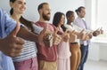 Multiracial group of happy young people smiling and showing thumbs up all together Royalty Free Stock Photo