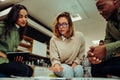 Diverse group of colleagues gather together to cover project presentation sitting in office lounge before presentation Royalty Free Stock Photo