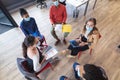 Diverse group of creative colleagues wearing face masks talking at meeting Royalty Free Stock Photo