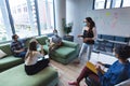 Diverse group of creative colleagues wearing face masks talking at meeting Royalty Free Stock Photo