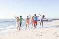 Diverse group of friends enjoy a day at the beach, with copy space Royalty Free Stock Photo
