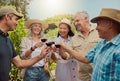 Diverse group of friends toasting with wineglasses on vineyard. Happy group of people standing together and bonding Royalty Free Stock Photo