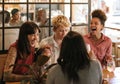 Diverse group of girlfriends laughing together in a trendy bar Royalty Free Stock Photo