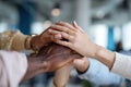 Diverse group of hands, including dark and light skin tones, stacked together in a collaborative gesture, symbolizing unity, Royalty Free Stock Photo