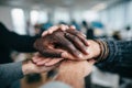 Diverse group of hands, including dark and light skin tones, stacked together in unity, symbolizing teamwork, collaboration, and Royalty Free Stock Photo