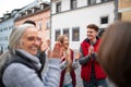 Diverse group of happy community service volunteers claping hands outdoors in street