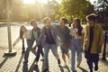 Diverse group of happy friends hanging out in the city, walking together and having fun